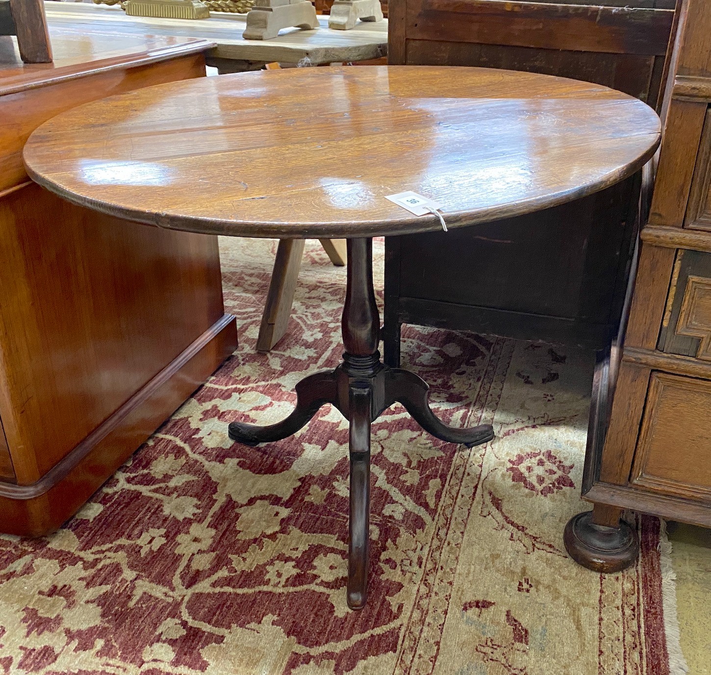 A George III circular oak tilt top birdcage tripod tea table, diameter 89cm, height 71cm